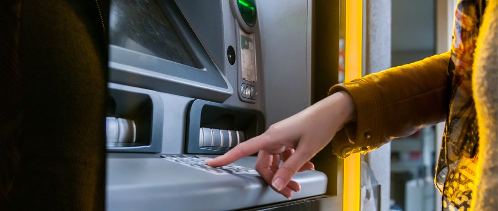 Banner image of person using cash point