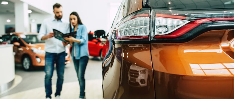 Banner image of couple buying a new car
