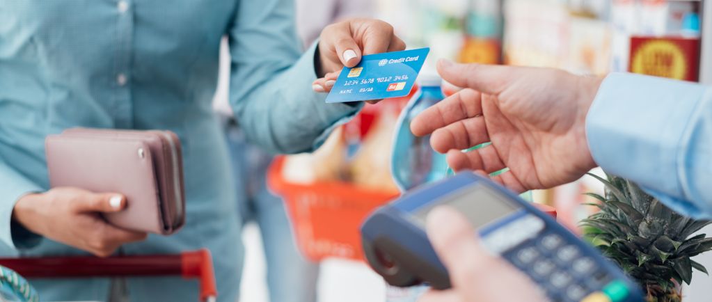 Banner image of shopper paying for goods with a credit card
