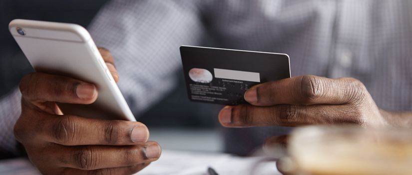Banner image of hands holding credit card and mobile