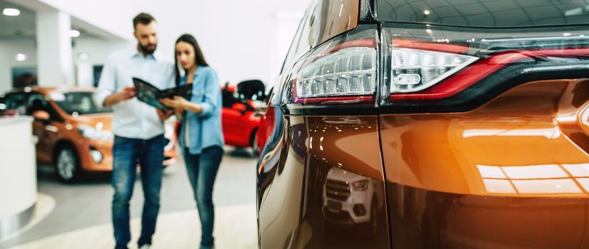 Banner image of couple buying a new car