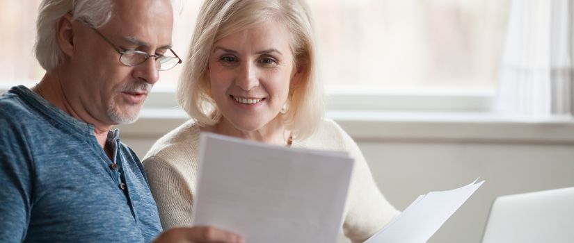Banner image of middle aged couple reviewing documents