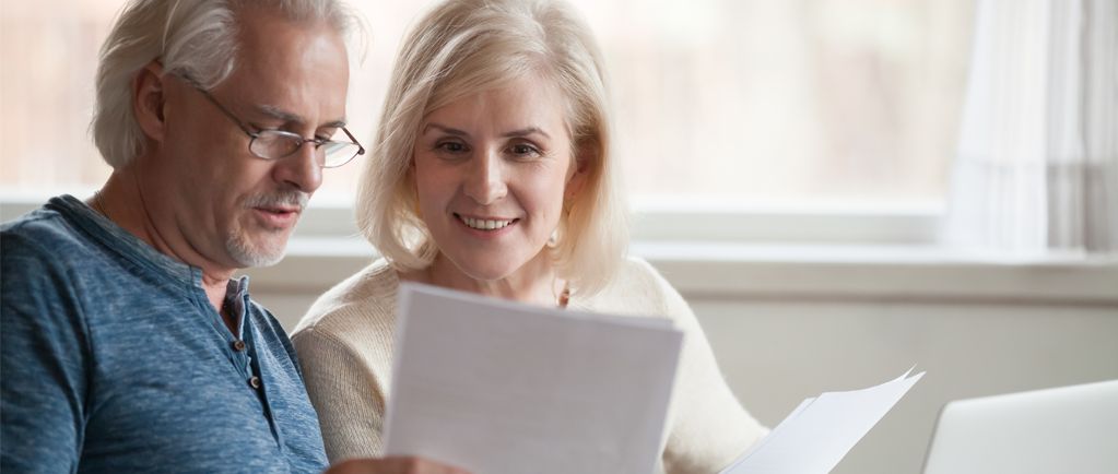 Banner image of middle-aged couple reviewing documents
