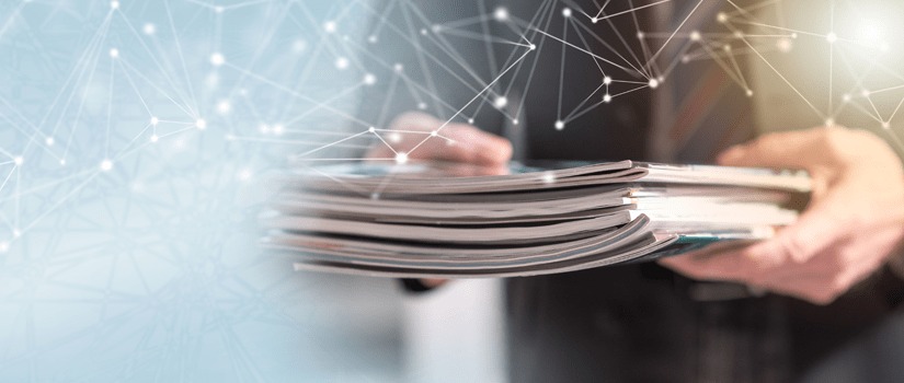 Banner Image of Business Man Holding a Stack of Magazines