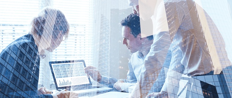 Banner image of three office workers reviewing financial data on a laptop screen