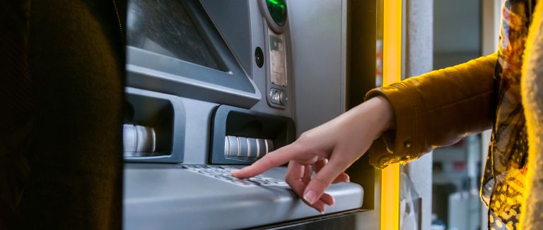 Banner image of person using cash point